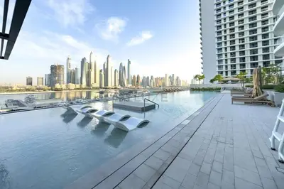 a swimming pool with a view of a city at Vacationer l Classy 1 Bedroom l Yacht Views l Private Beach in Dubai
