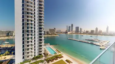 a rendering of a building next to a body of water at Vacationer l Classy 1 Bedroom l Yacht Views l Private Beach in Dubai