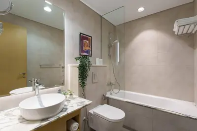a bathroom with a sink and a toilet and a tub at 5-Star Living | Luxury 2B & Amenities in Dubai