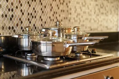 a group of pots sitting on top of a stove at 5-Star Living | Luxury 2B & Amenities in Dubai