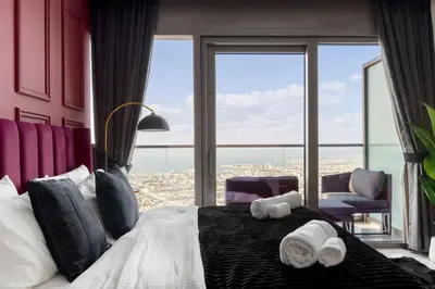 a bedroom with a bed with two towels on it at 5-Star Living | Luxury 2B & Amenities in Dubai