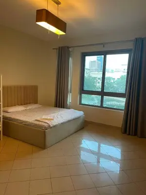 a bedroom with a bed and a large window at Stunning rooms in the Canal in Dubai