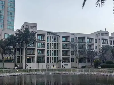 a large building next to a body of water at Stunning rooms in the Canal in Dubai