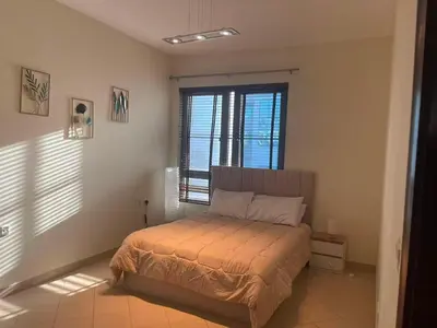 a bedroom with a bed in a room with windows at Stunning rooms in the Canal in Dubai
