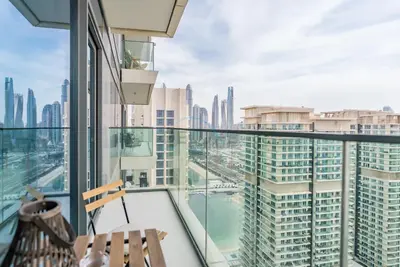 a balcony with a view of the city at Prime Waterfront Location with Stunning Palm Jumeirah Views, Close to Dubai Top Attractions - Beach Vista Tower 2, Emaar Beachfront by Deluxe Holiday Homes in Dubai