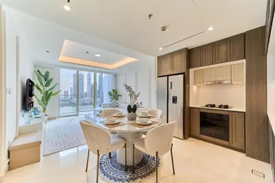 a kitchen and dining room with a table and chairs at Elegant Beachfront 2BR at Palace Beach Residence in Dubai