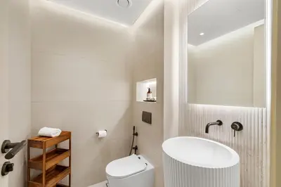 a bathroom with a white toilet and a sink at Upscale City Walk 3BR plus Maid Near Dubai Mall in Dubai