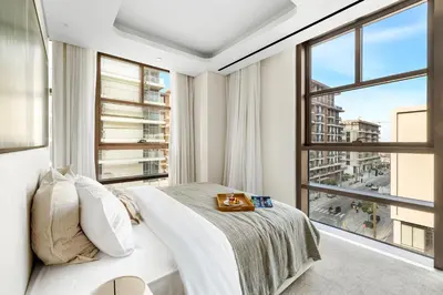a bedroom with a bed and a large window at Upscale City Walk 3BR plus Maid Near Dubai Mall in Dubai