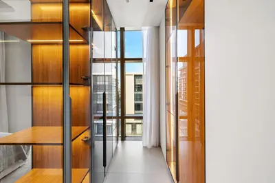 a hallway with glass doors and wood shelves at Upscale City Walk 3BR plus Maid Near Dubai Mall in Dubai