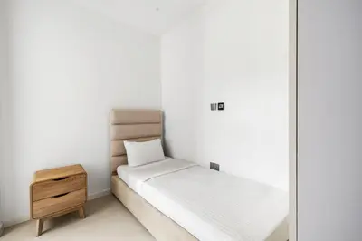 a small bedroom with a bed and a mirror at Upscale City Walk 3BR plus Maid Near Dubai Mall in Dubai