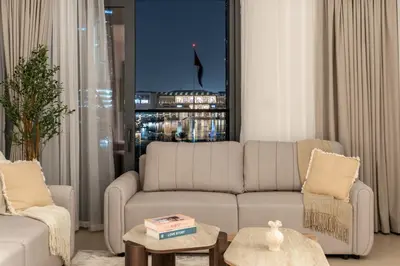 a living room with a couch and a window at Stunning 2BR with Full Burj View in the Opera District in Dubai