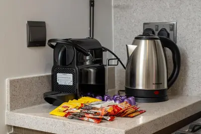 a counter with a coffee maker and a pile of food at Stunning 2BR with Full Burj View in the Opera District in Dubai