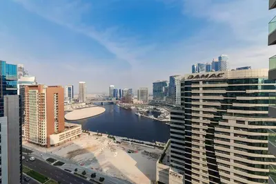 a view of a river in a city with buildings at Chic 1BR at Reva Stunning Canal Views in Dubai
