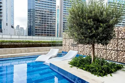 a tree on the roof of a building with a pool at Chic 1BR at Reva Stunning Canal Views in Dubai