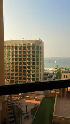 a view of a large building from a window at 1 Bhk with open terrace in Dubai