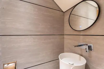 a bathroom with a sink and a mirror at GuestReady | Stylish 1BR Penthouse Retreat in Dubai