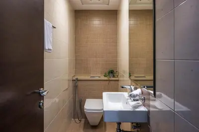 a bathroom with a white sink and a toilet at VayK - Amazing 1BR in Marina with Sea View in Dubai