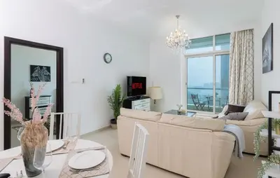 a living room with a couch and a table at VayK - Amazing 1BR in Marina with Sea View in Dubai