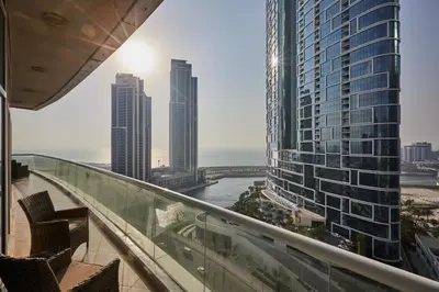 a view of the ocean from the balcony of a building at VayK - Modern 4BR in Dubai Marina with Sea View in Dubai