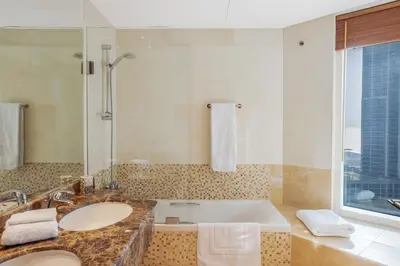 a bathroom with two sinks and a bath tub at VayK - Modern 4BR in Dubai Marina with Sea View in Dubai