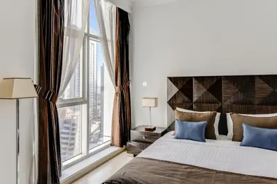 a bedroom with a bed and a large window at VayK - Modern 4BR in Dubai Marina with Sea View in Dubai