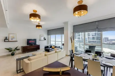 a living room with a couch and a table at VayK - Modern 4BR in Dubai Marina with Sea View in Dubai