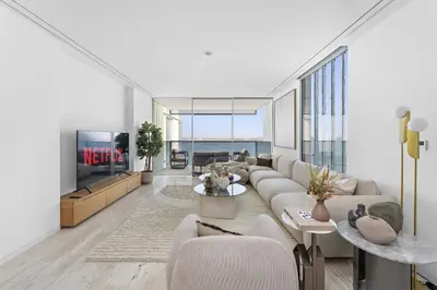 a living room with a couch and a tv at VayK - Ultra Luxury Muraba Residences in Palm in Dubai