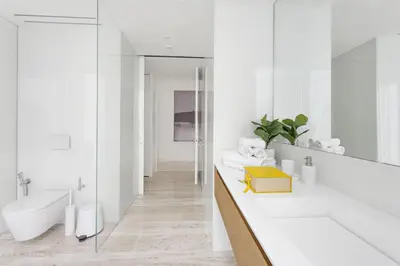 a white bathroom with a tub and a sink at VayK - Ultra Luxury Muraba Residences in Palm in Dubai
