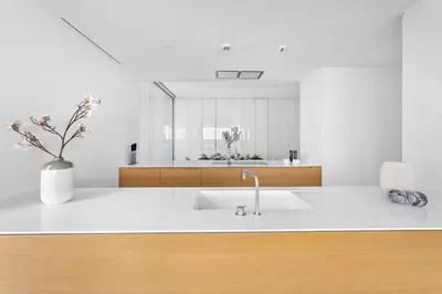 a white kitchen with a sink and a mirror at VayK - Ultra Luxury Muraba Residences in Palm in Dubai