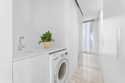 a white laundry room with a washing machine and a sink at VayK - Ultra Luxury Muraba Residences in Palm in Dubai