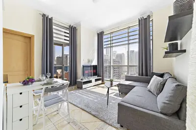 a living room with a couch and a table at VayK - Modern and Central 1BR in the Marina in Dubai
