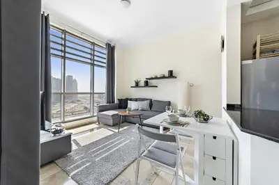 a kitchen and living room with a large window at VayK - Modern and Central 1BR in the Marina in Dubai