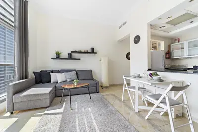 a living room with a couch and a table at VayK - Modern and Central 1BR in the Marina in Dubai