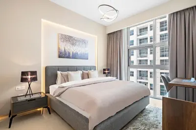 a bedroom with a king sized bed and a desk at VayK - Renovated 1BR in Dubai Marina in Dubai