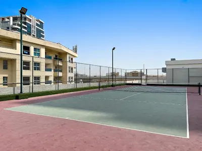 a tennis court in front of a building at VayK - Renovated 1BR in Dubai Marina in Dubai