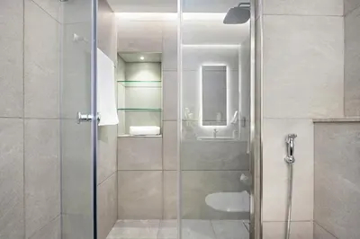 a shower with a glass door in a bathroom at VayK - Renovated 1BR in Dubai Marina in Dubai