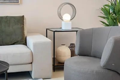 a living room with a chair and a table with a lamp at VayK - Renovated 1BR in Dubai Marina in Dubai