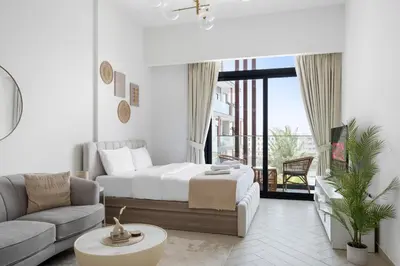 a bedroom with a bed and a couch and a table at VayK - Cozy Studio with a Balcony & Pool Views in Dubai