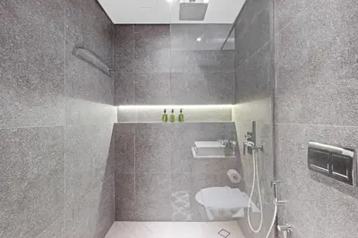 a bathroom with a shower with a toilet and a sink at VayK - Cozy Studio with a Balcony & Pool Views in Dubai