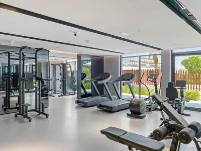 a gym with several treadmills and elliptical machines at VayK - Cozy Studio with a Balcony & Pool Views in Dubai