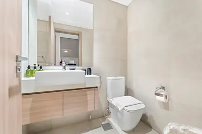 a bathroom with a white sink and a toilet at VayK - Modern Studio in Prime Meydan Area in Dubai