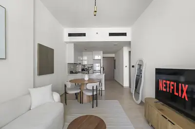 a living room with a couch and a table at VayK - Amazing 1BR in Jvc in Dubai