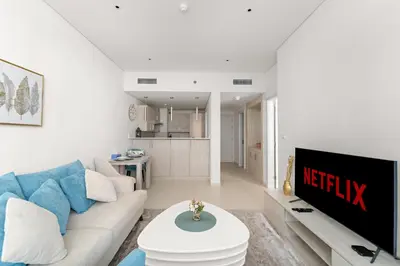 a living room with a couch and a table at VayK - Great 1BR with Beach Access in Dubai