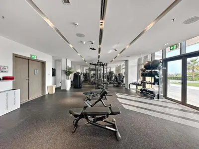 a gym with treadmills and ellipticals in a room at Upscale 1BR with Beach Access on Palm Jumeirah in Dubai
