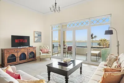 a living room with a view of the ocean at VayK - Beachfront 1BR on Palm Jumeirah with Sea View in Dubai