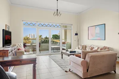 a living room with a couch and chairs and a table at VayK - Beachfront 1BR on Palm Jumeirah with Sea View in Dubai