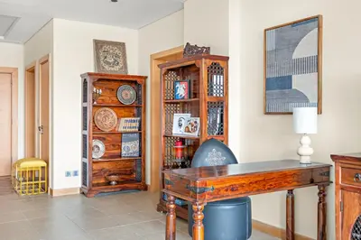 a home office with a wooden desk and a cabinet at VayK - Beachfront 1BR on Palm Jumeirah with Sea View in Dubai