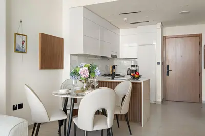 a kitchen and dining room with a table and chairs at VayK - Heavenly Brand New 1BR in Jvc in Dubai