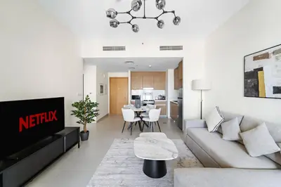 a living room with a couch and a table at VayK - Modern 1BR Getaway in Creek Harbour in Dubai