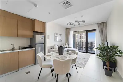 a kitchen and dining room with a table and chairs at VayK - Modern 1BR Getaway in Creek Harbour in Dubai